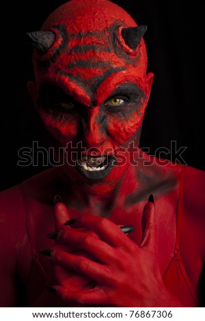 Red devil woman. Low key lighting.