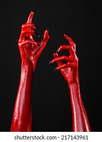Red Devil's hands, Halloween theme, black background, isolated