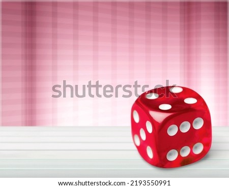 Red dice on the edge on background, red hexagonal cube.