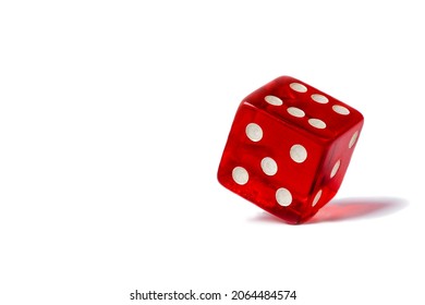 Red dice standing in equilibrium on the edge and showing 6 isolated on a white background, red hexagonal cube standing in equilibrium on the edge and showing 6