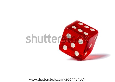 Red dice standing in equilibrium on the edge and showing 6 isolated on a white background, red hexagonal cube standing in equilibrium on the edge and showing 6