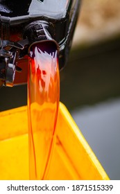 Red Diesel Being Poured Into A Container In A Steady Stream