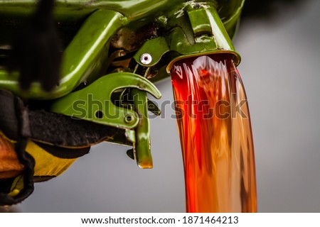red diesel being poured into a container in a steady stream