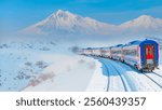 Red diesel train (East express) in motion at the snow covered railway platform - The train connecting Ankara to Kars - Passenger train going through tunnel 