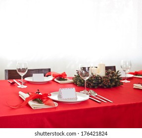 Red dinner table setup with name place card