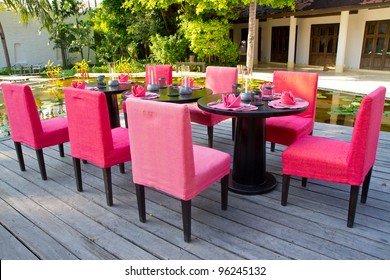 Red Dinning Table Set In The Garden