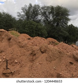 Red Dirt In Large Pile With Trees