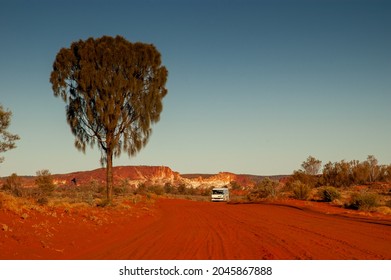 Red dirt road and desert oak tree leading into Rainbow Valley Conservation Reserve in outback Central Australia, south of Alice Springs. - Powered by Shutterstock