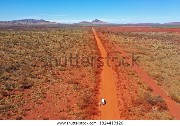 red dirt road heading toward Hamersley Gorge and\
Karijini National Park