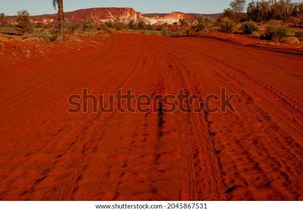 Red dirt road\
into Rainbow Valley Conservation Reserve in outback Central\
Australia, south of Alice\
Springs.