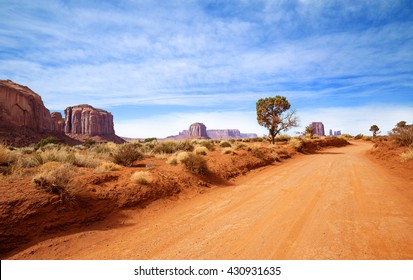 Red Dirt Road In Rocky Desert Scenery