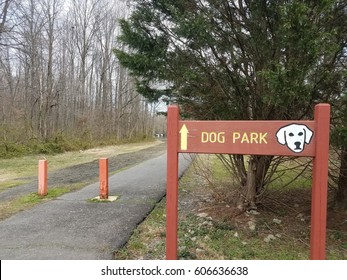 Red Dog Park Sign With White Dog And Asphalt Trail