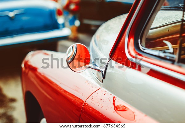 The red door of an old\
Soviet car