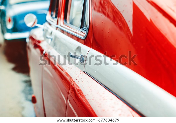 The red door of an old\
Soviet car