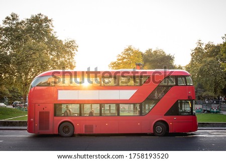 Red Double Decker Bus of London Parked Near the Park by Sunset