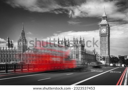 Red double decker bus with motion blur on Westminster bridge, Big Ben in the background, in London, UK. Black and white with selective color