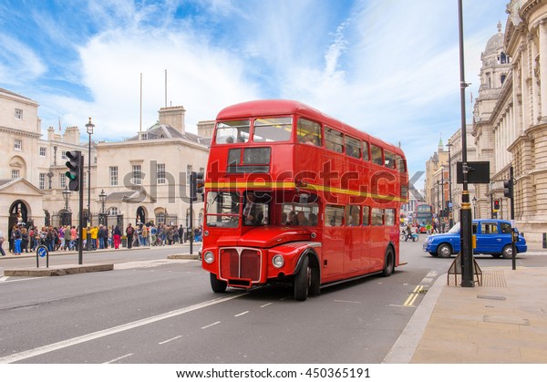 red double decker\
vintage bus in a street
