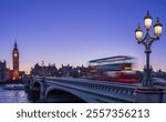 Red double-decker bus crosses Westminster Bridge at dusk with Big Ben in the background