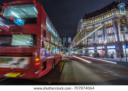  Red double-decker bus. Pedestrian and traffic in Oxford Circus at night in London, UK