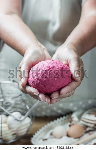 Red\
dough for pasta. Woman making red dough for pasta. Ready dough.\
Step by step process of making red pasta. See\
series.