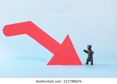 Red Downward Arrow Beside A Bear Animal Figure. Bearish Run In Stocks And Cryptocurrency Market Trading Concept.