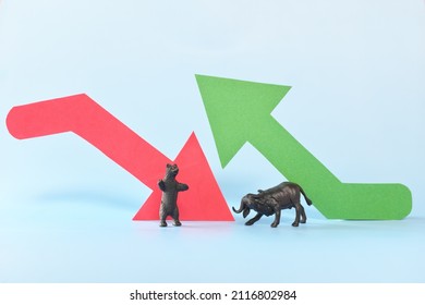 Red downward arrow and green upward arrow beside a bear and bull animal figure. Bearish versus Bullish market clash in stocks and cryptocurrency trading concept.