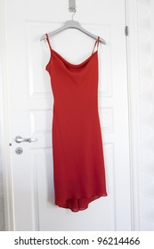 Red Dress Hanging On A Door