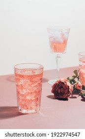 Red Drink Cocktail Or Lemonade With Ice In A Glass On Pink Background.