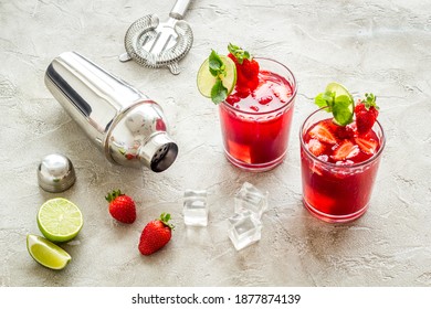 Red drink coktail with strawberry, ice and mint. Cocktail making bar tools