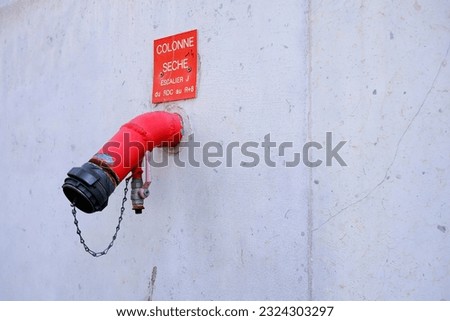 Red Dry Fire Riser Pipe.   (Translation Texts on Sign is COLUMN DRY STAIRCASE J from ground floor to R+8) [[stock_photo]] © 