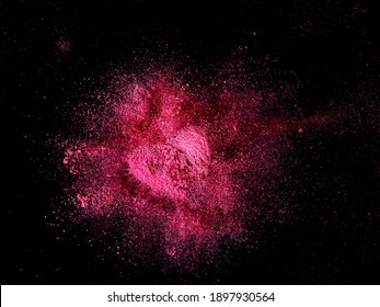 Red dust heart explosion on black background