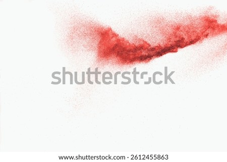 Red dust particles explosion on white background.Red sand splatter.