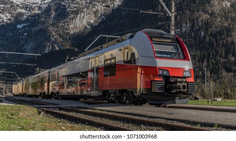 Red Electric Fast Train In Austria Alps Mountains