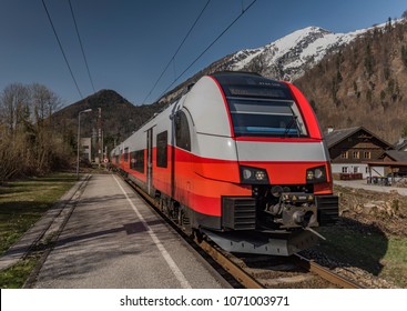 Red Electric Fast Train In Austria Alps Mountains