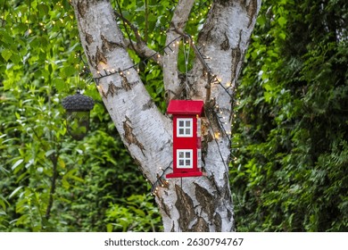 Red Electric Switch Boxes Mounted on White Birch Tree Trunk in Urban Green Space