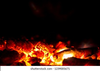 Red ember on black background. Hot red embers background.