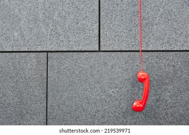 Red Emercency Call Phone Hanging Down On A Wall