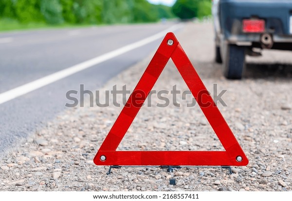 a red
emergency sign stands on the side of the
road	