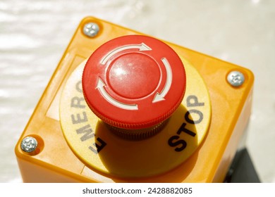 A red Emergency STOP button used for safety on industrial equipment, machine machinery electrical system emergency shutdown mechanism, nuclear power plant, factory, workers safety security concept - Powered by Shutterstock