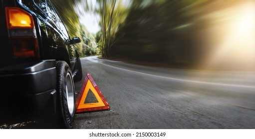 Red Emergency Stop Sign (red Triangle Warning Sign) And Broken Black SUV Car  On Country Road.Accident,insurance And Travel  Concept Background.