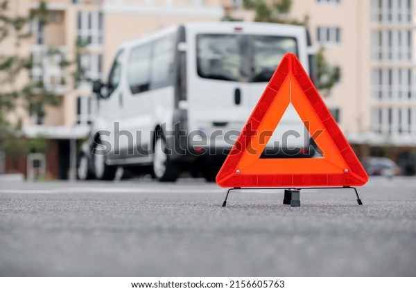 Red emergency\
triangle stop sign on road