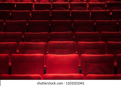Red empty chairs in the theatre