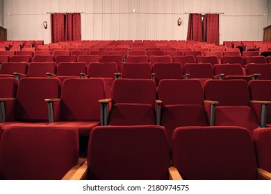 Red Empty Chairs In The Theatre. An Empty Movie Theater During A Lockdown. The Theater Is Quarantined. Closing Of Cinemas. The Absence Of Spectators In The Cinema.