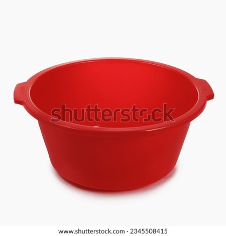 Red empty plastic basin on white isolated background