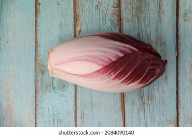 Red Endive On A Wooden Table