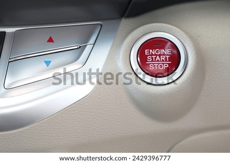 Red engine start stop button in modern car