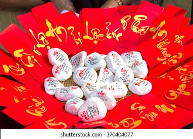 Red envelopes with text "property, fortune, happy new year" in Vietnamese next to the write calligraphy is also for sale in the first day was beautiful and meaningful