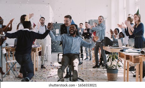 RED EPIC-W Happy young black businessman celebrating birthday at office workplace party with confetti slow motion.