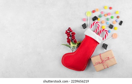 Red Epiphany Befana's stocking with sweet coal and candy on light gray background, Italian Epiphany day tradition for children to give a stocking full of sweets. Top view, flat lay, above - Powered by Shutterstock