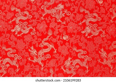 Red fabric with a dragon pattern. The concept of the Chinese New Year. copy space. Red background. - Powered by Shutterstock